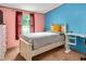 Cozy bedroom with light colored bed, desk and bright painted walls at 1007 Windward Hill Ct, Middlesex, NC 27557