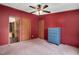 Spacious bedroom features neutral carpet, ceiling fan, and painted blue dresser at 1007 Windward Hill Ct, Middlesex, NC 27557