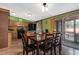 Dining area features a large table for eight, seamlessly connecting to the kitchen and outdoor spaces at 1007 Windward Hill Ct, Middlesex, NC 27557