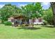 A well-maintained single story home with red shutters and roof and a charming covered front porch at 1007 Windward Hill Ct, Middlesex, NC 27557