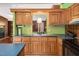 Functional kitchen with ample counter space, wood cabinets, modern black appliances, and stainless steel sink at 1007 Windward Hill Ct, Middlesex, NC 27557