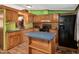 Functional kitchen with ample counter space, wood cabinets, modern black appliances, and an eat-in island at 1007 Windward Hill Ct, Middlesex, NC 27557