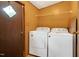 A compact laundry room with stacked washer and dryer, and shelving unit at 1007 Windward Hill Ct, Middlesex, NC 27557