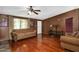 Comfortable living room featuring hardwood floors, a ceiling fan, neutral paint, and natural light at 1007 Windward Hill Ct, Middlesex, NC 27557