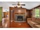 Inviting living area with hardwood floors, a ceiling fan, and a cozy stone fireplace at 1007 Windward Hill Ct, Middlesex, NC 27557