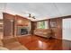 Spacious living room with hardwood floors, a stone fireplace, a ceiling fan and a comfortable sofa at 1007 Windward Hill Ct, Middlesex, NC 27557