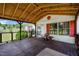 Inviting porch with wood flooring, red accents, and a comfortable seating area, perfect for outdoor relaxation at 1007 Windward Hill Ct, Middlesex, NC 27557