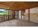 Cozy screened porch with wood floors, lattice design, and entrance into the home create a warm, inviting transition at 1007 Windward Hill Ct, Middlesex, NC 27557