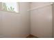 This closet features neutral wall paneling, a wooden shelf, and a small window for natural light at 101 Cottonwood Ct, Kenly, NC 27542