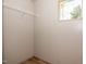 Neutral colored closet with a white wire shelf and a small window for natural light at 101 Cottonwood Ct, Kenly, NC 27542