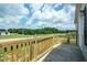 Spacious porch with wooden railing, offering a tranquil outdoor space with a scenic neighborhood view at 101 Cottonwood Ct, Kenly, NC 27542