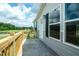 Wide view of the spacious porch, showcasing the light gray exterior and black window shutters at 101 Cottonwood Ct, Kenly, NC 27542