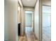 Hallway features wood-look vinyl flooring and neutral-toned wall paneling, offering access to various rooms at 101 Cottonwood Ct, Kenly, NC 27542