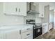 Bright kitchen features white cabinets, stainless steel appliances, and modern countertops at 101 Cottonwood Ct, Kenly, NC 27542