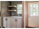 Bright kitchen features ample cabinet space, floating shelves, and a window at 101 Cottonwood Ct, Kenly, NC 27542