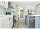 Modern kitchen with stainless steel appliances, white cabinets, and a gray kitchen island at 101 Cottonwood Ct, Kenly, NC 27542