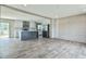 Open-concept living space with stylish gray flooring, flowing seamlessly into the modern kitchen at 101 Cottonwood Ct, Kenly, NC 27542