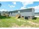 Back view of the home, showing the wooden deck, new siding, and air conditioning unit at 103 Cottonwood Ct, Kenly, NC 27542