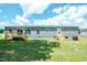 Back exterior view of home featuring wooden deck, new siding and well-kept lawn at 103 Cottonwood Ct, Kenly, NC 27542