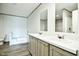 A well-lit bathroom features double vanity with a tub and shower combo at 103 Cottonwood Ct, Kenly, NC 27542