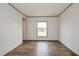 A new, empty bedroom with light-colored flooring and a window with an open view at 103 Cottonwood Ct, Kenly, NC 27542