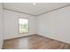An empty bedroom with modern light-colored flooring, one window, and white walls at 103 Cottonwood Ct, Kenly, NC 27542