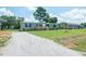 Bright and sunny home featuring a gravel driveway and well maintained lawn at 103 Cottonwood Ct, Kenly, NC 27542