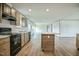 Open concept kitchen featuring an island, stainless appliances, and lots of cabinets at 103 Cottonwood Ct, Kenly, NC 27542
