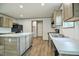 Spacious kitchen featuring a kitchen island, modern appliances, and wood-look flooring at 103 Cottonwood Ct, Kenly, NC 27542