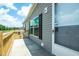 A long gray home featuring a concrete side porch and railing at 103 Cottonwood Ct, Kenly, NC 27542