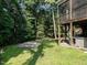 Expansive backyard with lush lawn, screened porch, hot tub, and surrounding trees at 106 Dodge Ln, Smithfield, NC 27577