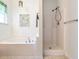 Stylish bathroom featuring a soaking tub and a separate walk-in shower at 106 Dodge Ln, Smithfield, NC 27577