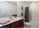 Well-lit bathroom features a modern vanity with a large mirror and a shower/tub combination at 106 Dodge Ln, Smithfield, NC 27577