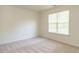Bedroom with neutral walls and flooring with a window for natural light at 106 Dodge Ln, Smithfield, NC 27577