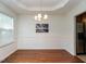 Elegant dining room with hardwood floors, tray ceiling, chandelier, and wainscoting at 106 Dodge Ln, Smithfield, NC 27577