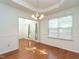 Elegant dining room with hardwood floors and a view into the entry foyer with front door at 106 Dodge Ln, Smithfield, NC 27577