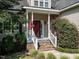 Inviting front porch with brick steps and decorative hanging flowers creating a welcoming entrance at 106 Dodge Ln, Smithfield, NC 27577
