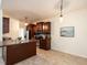 Kitchen featuring warm wood cabinetry, stainless steel appliances, and tiled floor at 106 Dodge Ln, Smithfield, NC 27577