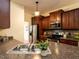 Kitchen featuring stainless steel appliances, warm wood cabinets and dark countertops at 106 Dodge Ln, Smithfield, NC 27577