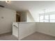 Upstairs landing features a railing, neutral carpet, and natural light from nearby windows at 106 Dodge Ln, Smithfield, NC 27577
