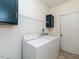 Functional laundry room with washer, dryer, cabinets and tiled floor at 106 Dodge Ln, Smithfield, NC 27577