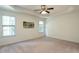 Bright main bedroom featuring neutral carpet, tray ceiling with fan, and natural light at 106 Dodge Ln, Smithfield, NC 27577