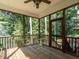 Relaxing screened porch features wood floors, ceiling fan, and views of the surrounding trees at 106 Dodge Ln, Smithfield, NC 27577