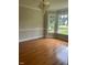 Formal dining room with hardwood floors, wainscotting, and large bay windows offering natural light and scenic views at 1109 Beechwood Dr, Rocky Mount, NC 27803