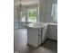 Eat-in kitchen featuring breakfast bar, tile floors, bay windows, and white cabinets offering a functional space at 1109 Beechwood Dr, Rocky Mount, NC 27803