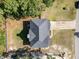 An aerial view of a cozy home featuring a large driveway and mature trees creating a private, wooded lot at 115 Baystone Dr, Sanford, NC 27332