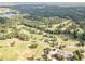 An aerial view reveals a golf course community, offering a lush, green landscape with scenic fairways and water features at 115 Baystone Dr, Sanford, NC 27332