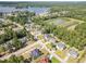 This aerial view features homes in a lakeside community with lush trees, providing scenic beauty and neighborhood charm at 115 Baystone Dr, Sanford, NC 27332