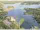 This aerial view features a community beach with a marina and boat launch, set against a beautiful lake backdrop at 115 Baystone Dr, Sanford, NC 27332