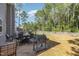 Large backyard with a well-maintained lawn, patio seating, grill, and privacy fence, perfect for entertaining at 115 Baystone Dr, Sanford, NC 27332